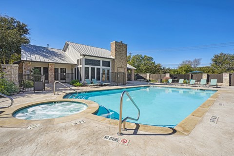 Our resort-style pool with a hot tub behind the leasing office at On the Green apartments in Austin, TX